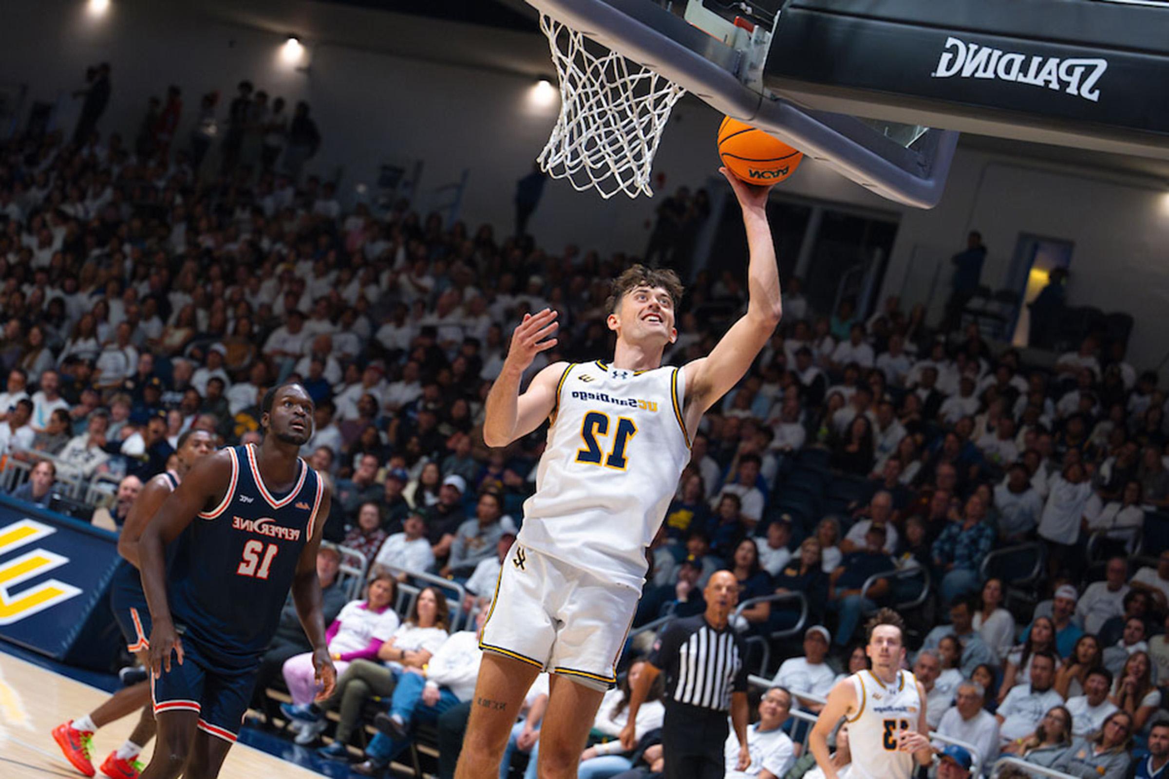 Triton basketball player shoots ball at rim